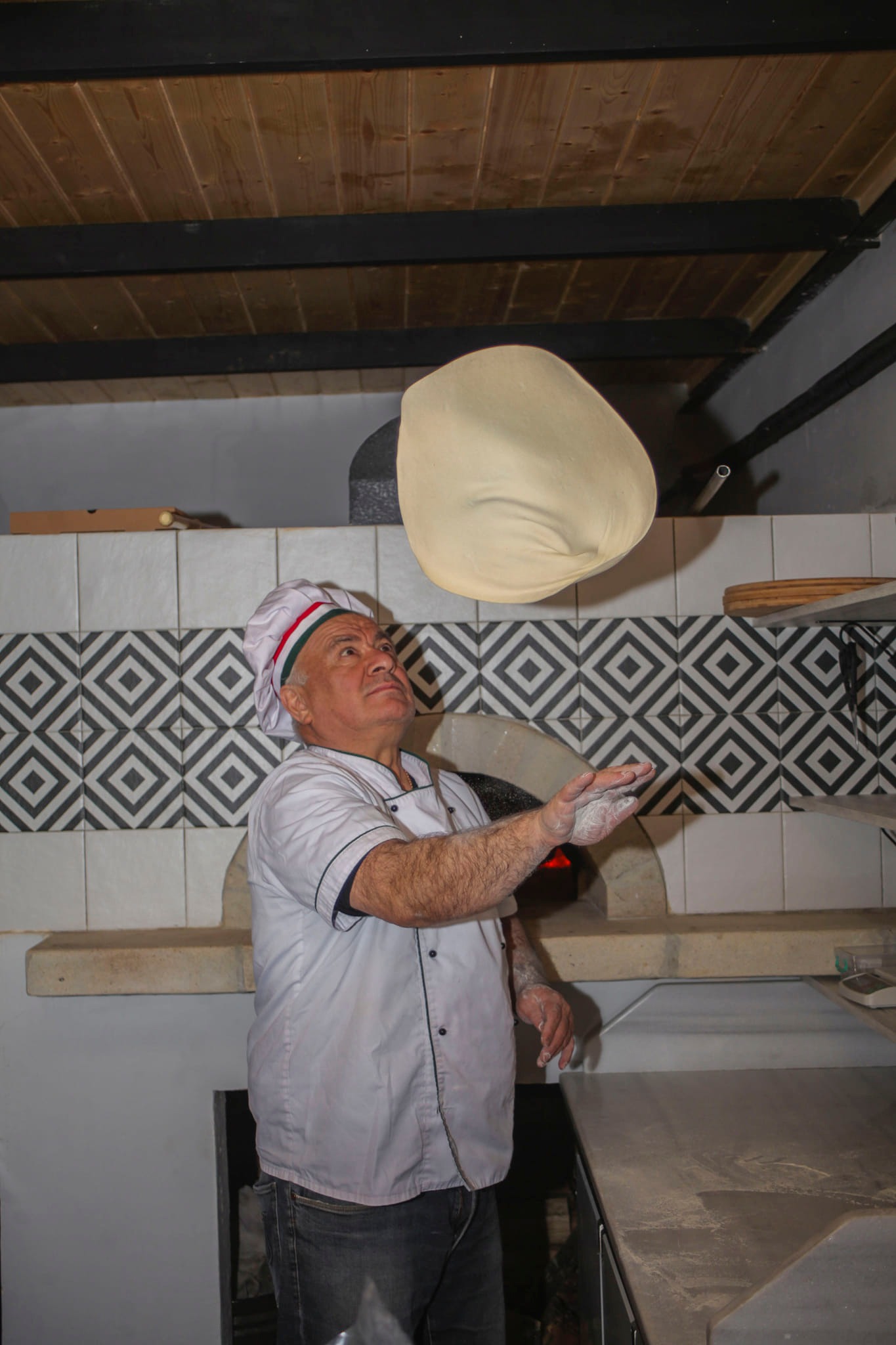 Chef tossing pizza dough